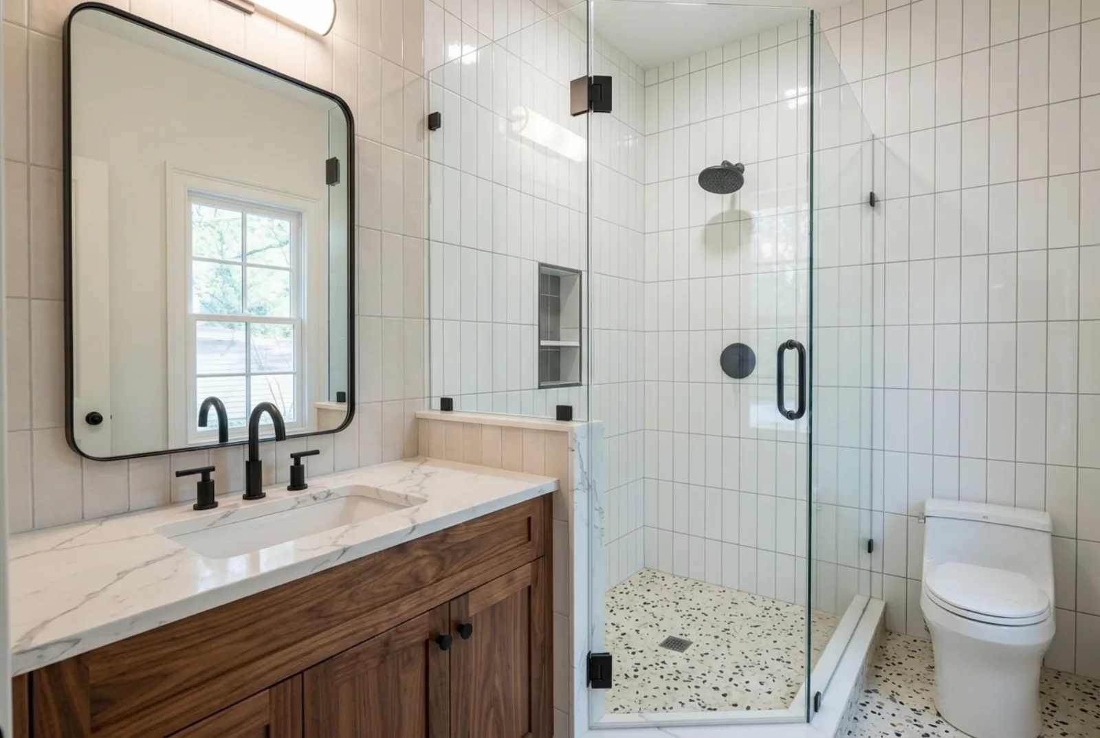 Remodeled Bathroom with Walnut Vanity and Subway Tile Shower