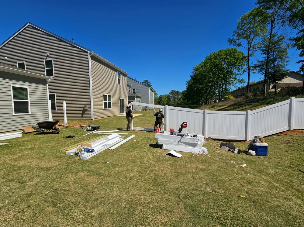 iFIXX crew installing a white vinyl privacy fence in South Charlotte